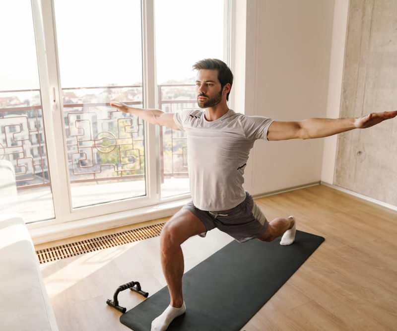 Man performing a lunge stretch to improve men’s mobility and longevity at home